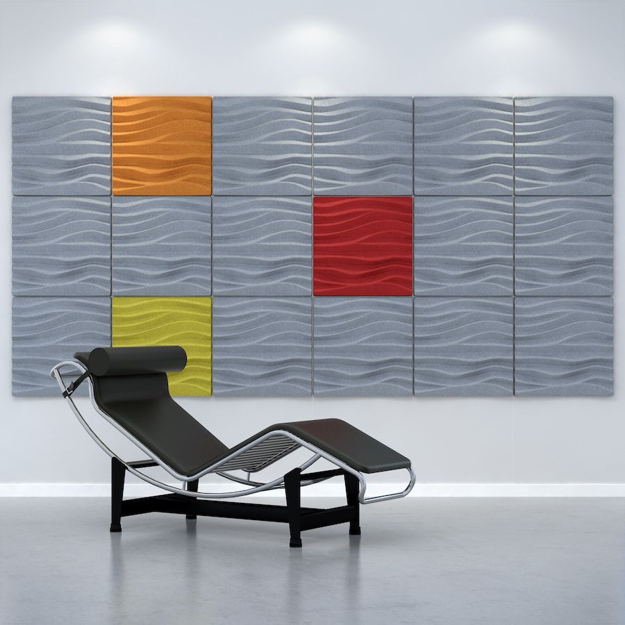 Image of grey, orange, red & yellow Sand acoustic tiles with a rippled texture attached to a wall. There is a lounger in front the wall. Acoustic tiles from Acoustek's Newport collection, sold & manufactured by Acoustek Australia & UK.