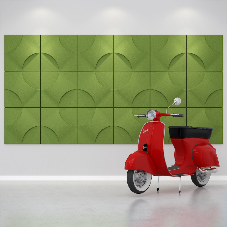 Image of green Torino acoustic tiles on a wall behind a red scooter. Acoustic tiles from Acoustek's Cavassini collection. Manufactured by & available to purchase from Acoustek Australia & UK.