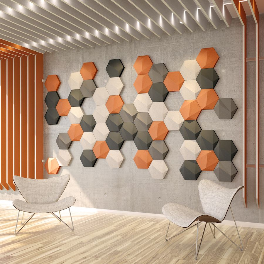 Image of orange, white, black and grey acoustic tiles from Acoustek's Porto collection attached to a wall. There are also acoustic blades attached to the wall and ceiling.